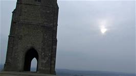 Moody skies, a watery sun and chilly conditions on Glastonbury Tor